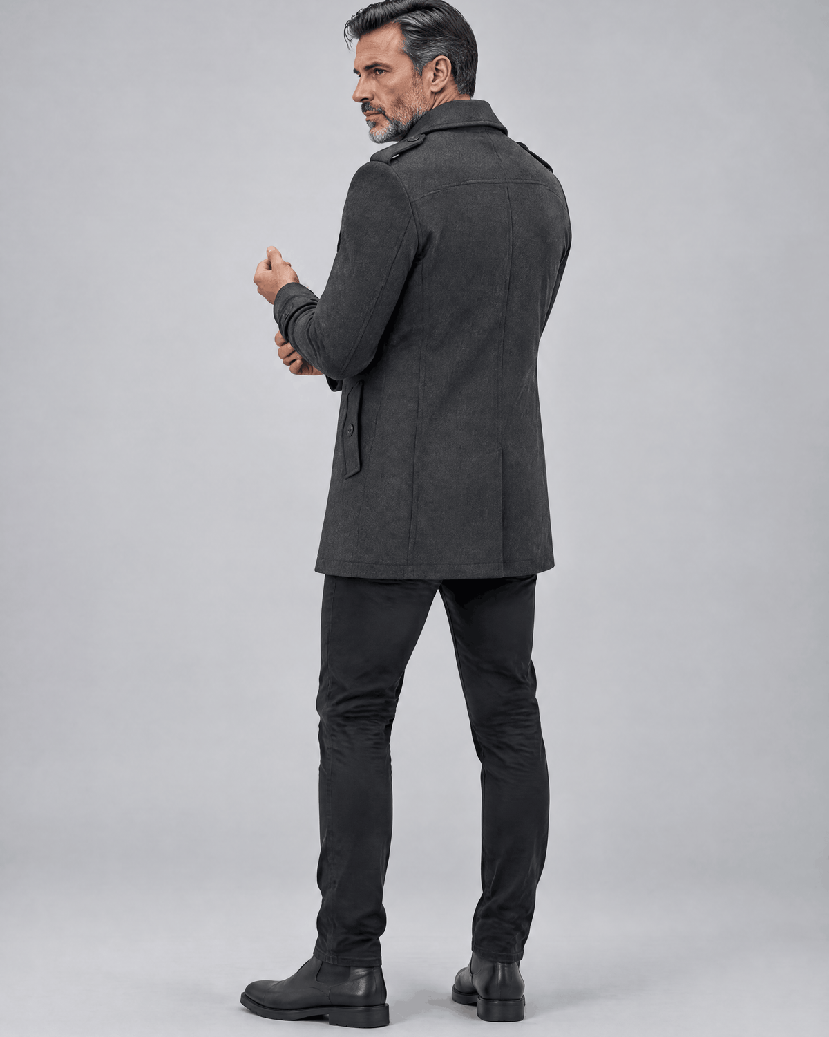 Back of the gray coat showing a clean back panel with the man turned over his shoulder