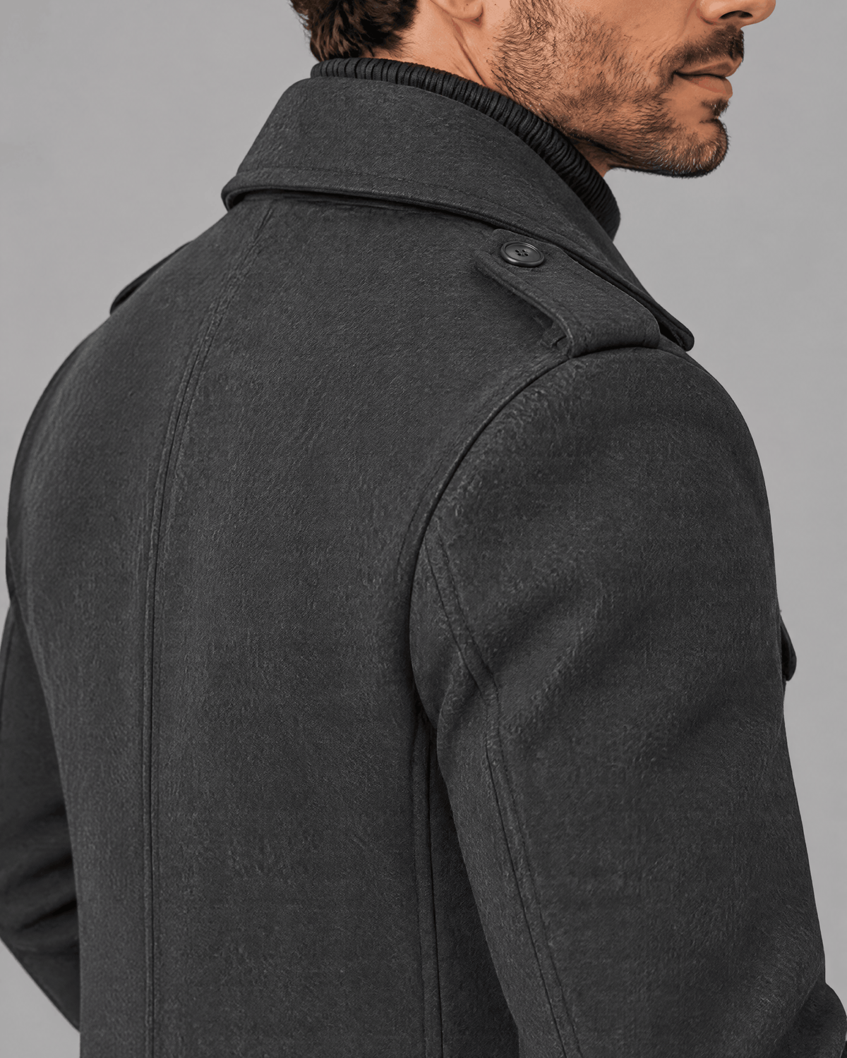 Gray coat shoulder and collar close-up showing the epaulette and woven texture