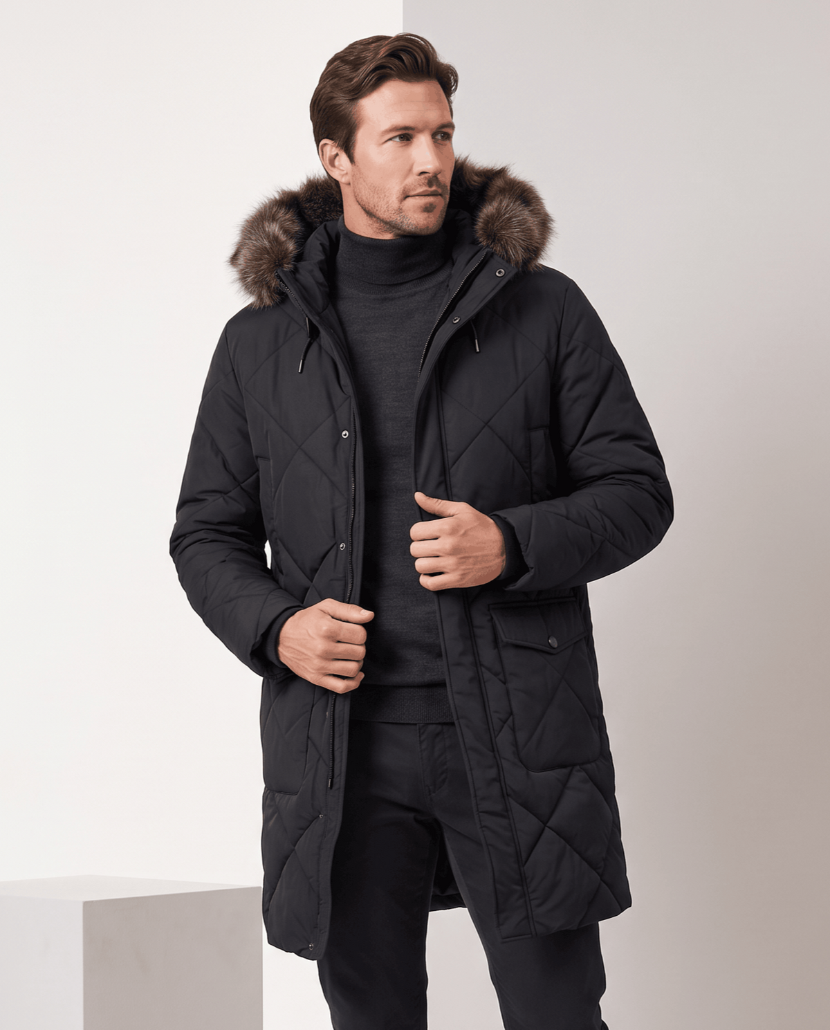 Men's black quilted long parka, front view with fur-trim hood