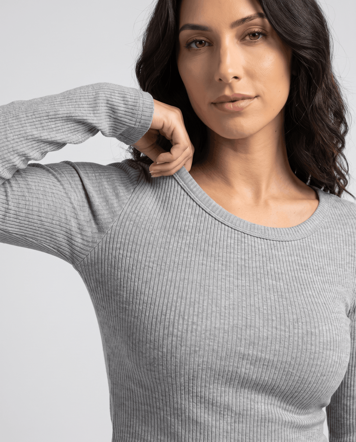 Gray crew-neck top close-up showing the neckline and ribbed long sleeve