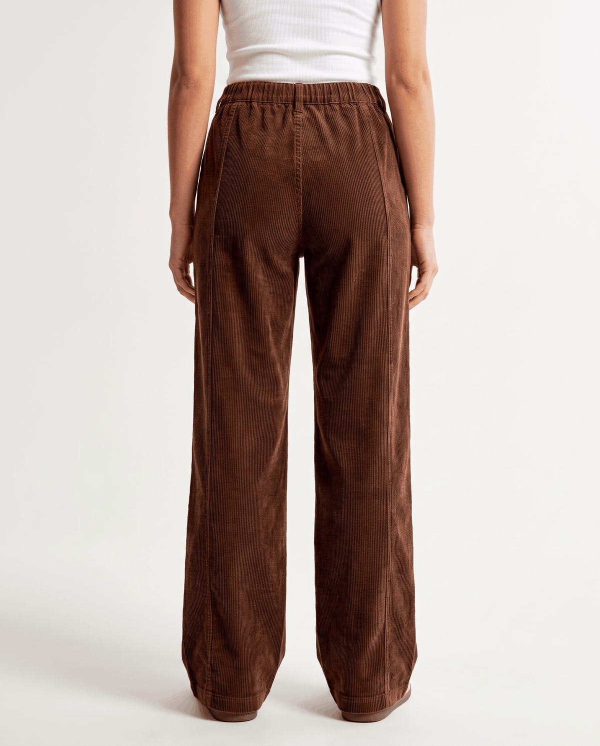 Back view of brown wide-leg trousers showing the elastic waist and full-length hem