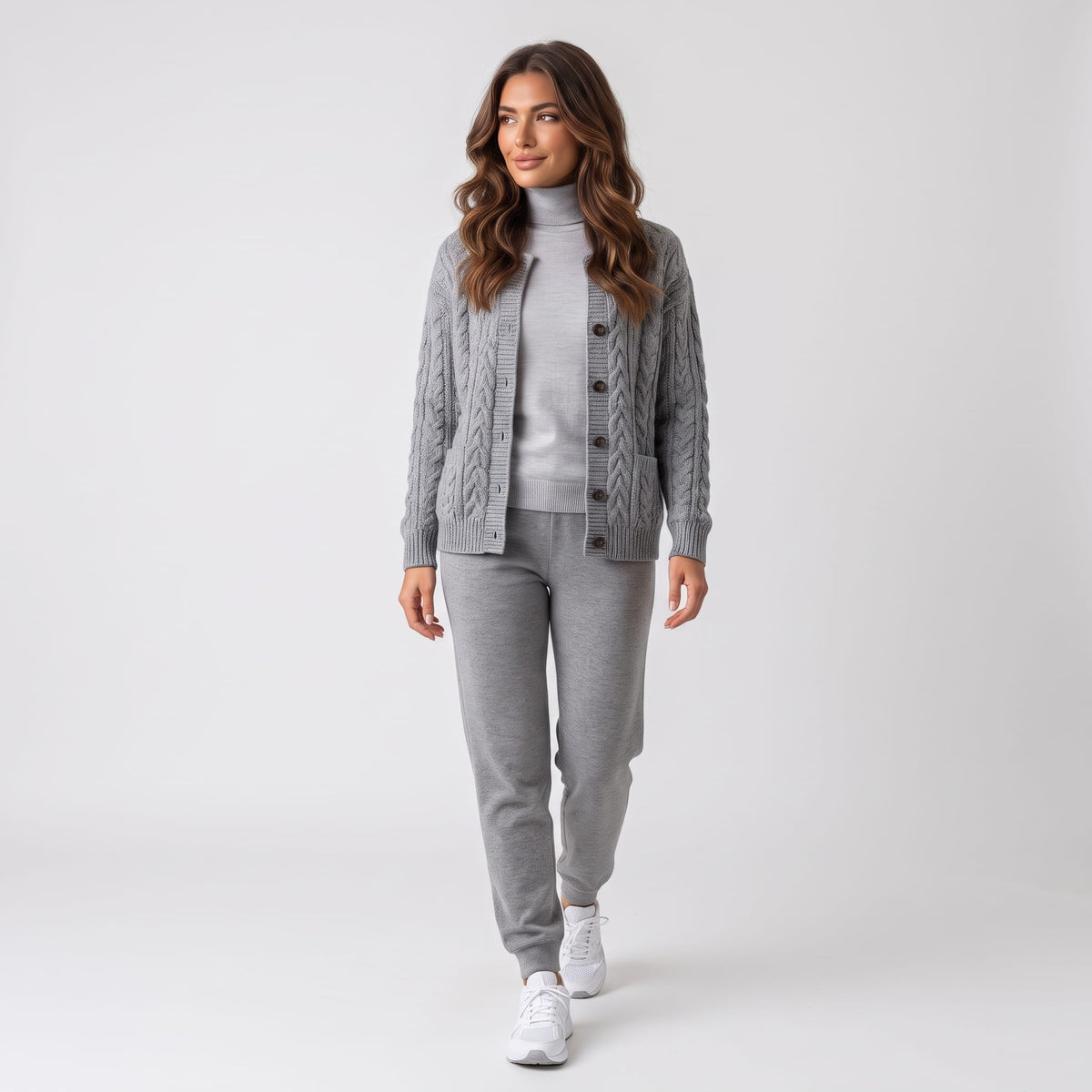 Full-length look with gray cable-knit cardigan, gray trousers and white sneakers
