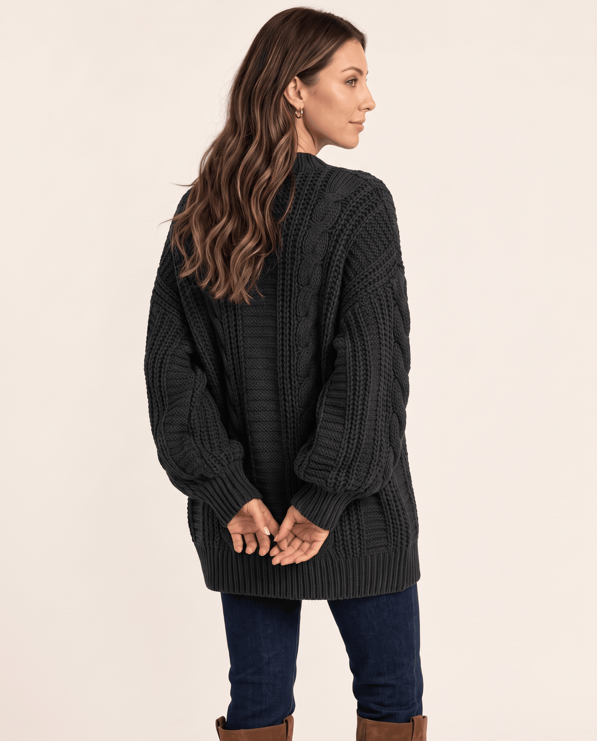 Back view of a charcoal cable knit cardigan with a relaxed shape