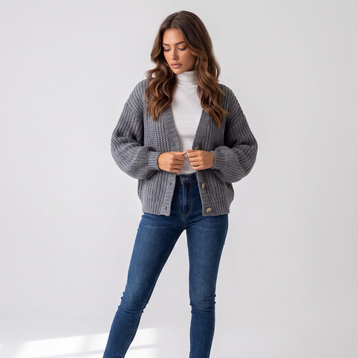 Full-length look with gray chunky knit cardigan and blue jeans