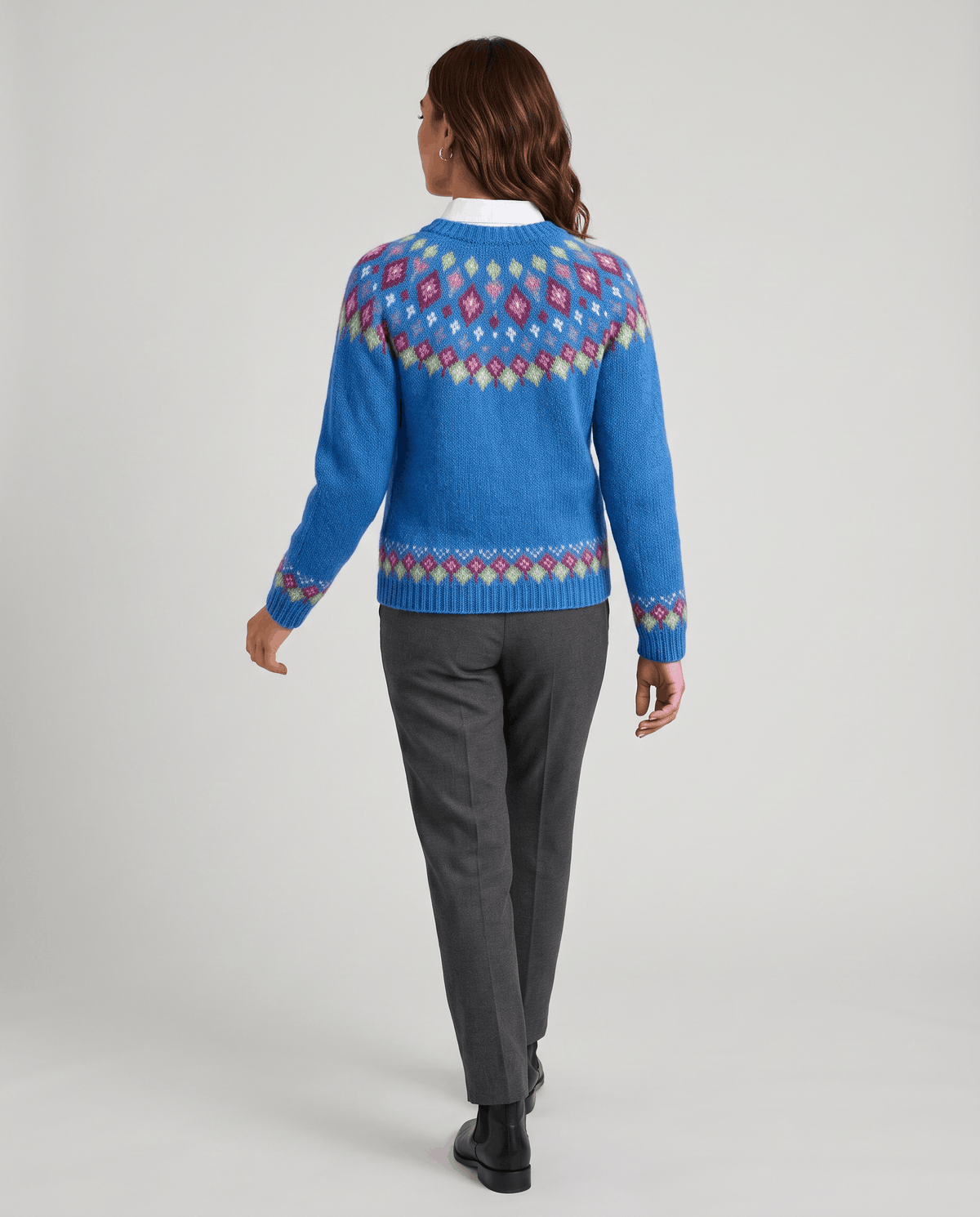 Back view of a blue Fair Isle cardigan with a patterned yoke and trousers