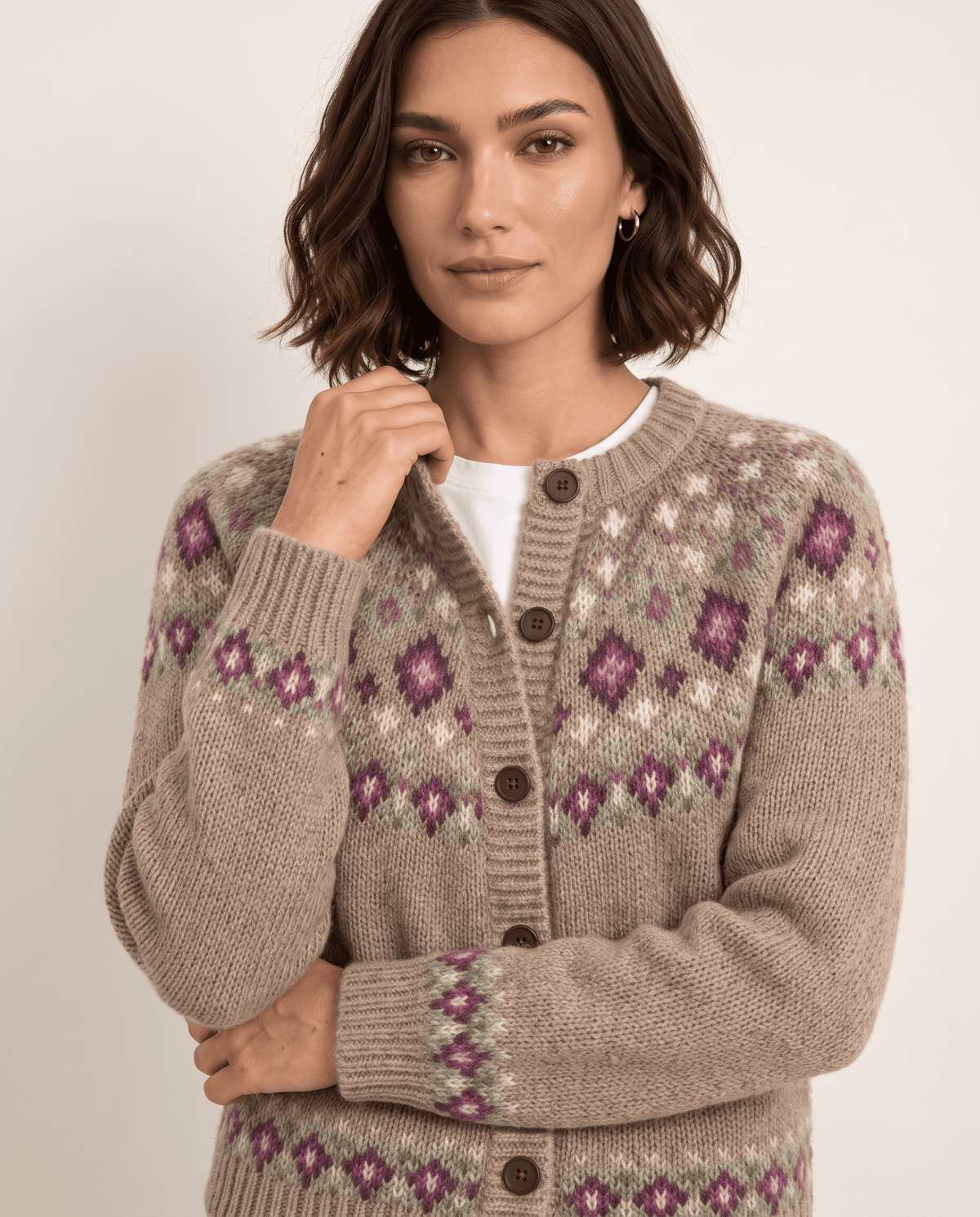 Close-up of camel Fair Isle diamond pattern, ribbed edge and brown buttons