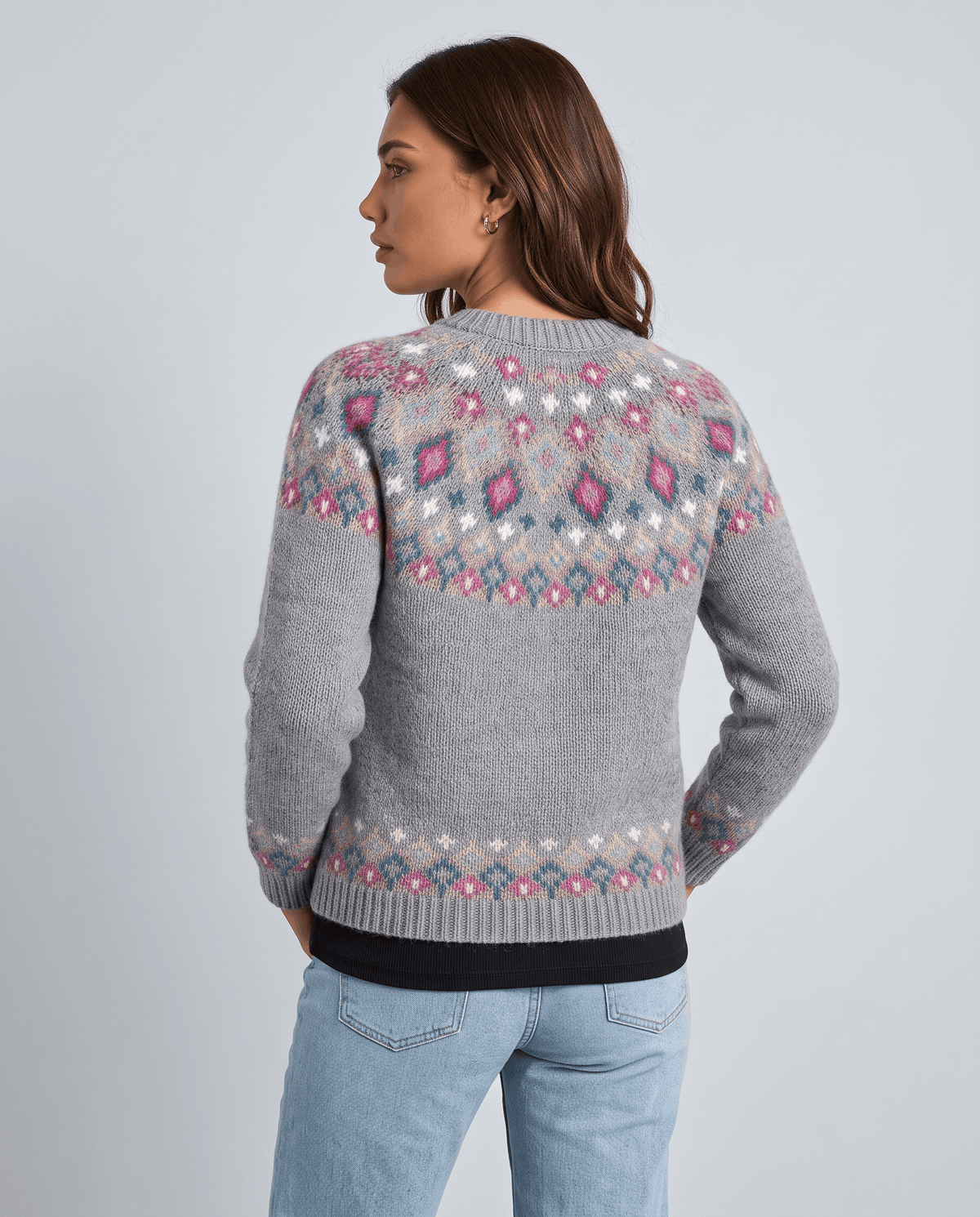 Back view of a gray Fair Isle cardigan showing the patterned yoke