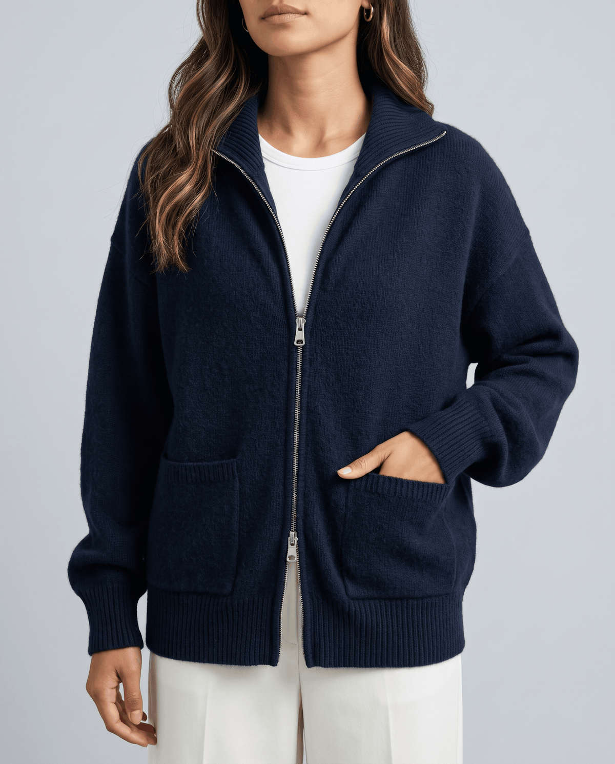 Close-up of navy soft knit with ribbed cuff and zip detail