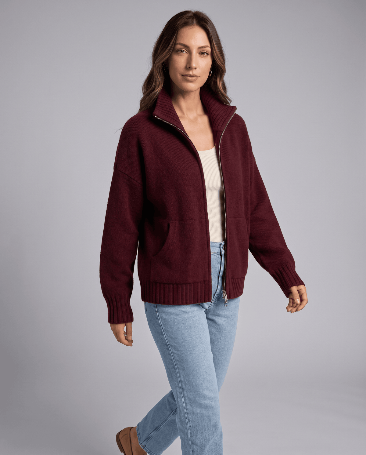Three-quarter view of a wine red funnel neck cardigan with front zip