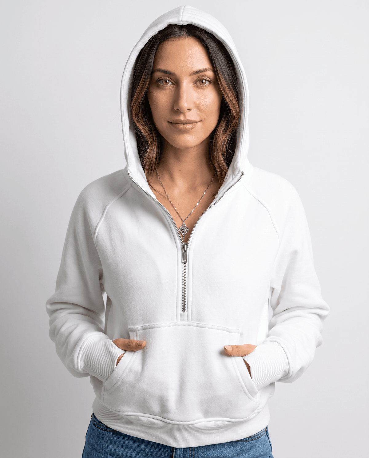 White half zip hoodie with a front kangaroo pocket worn with jeans, front view