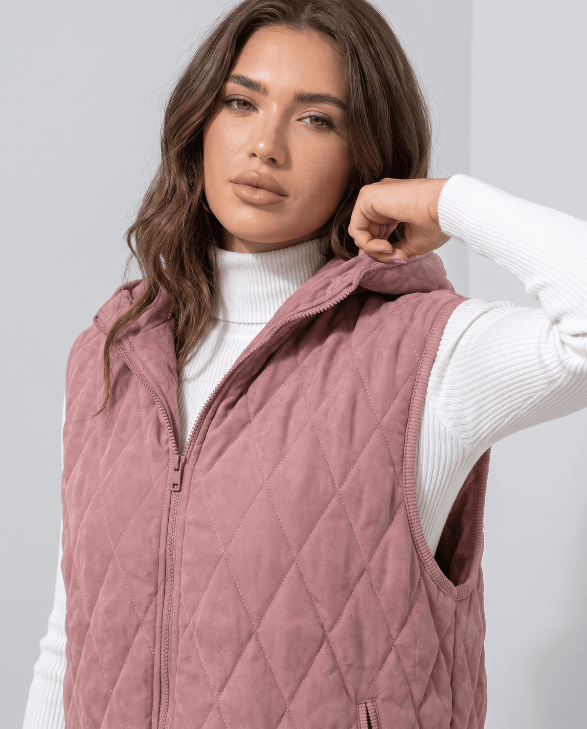 Pink quilted vest full zip and hood shown up close