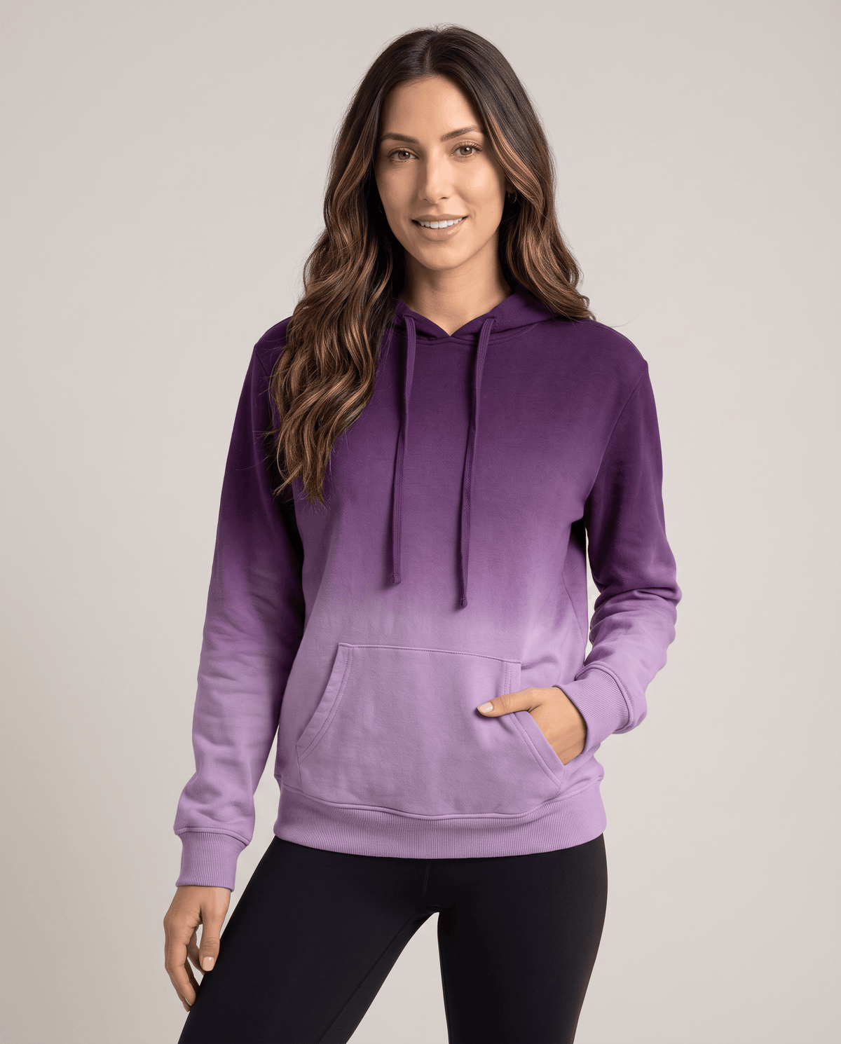 Purple gradient pullover with a hand in the front pocket and black leggings, front view