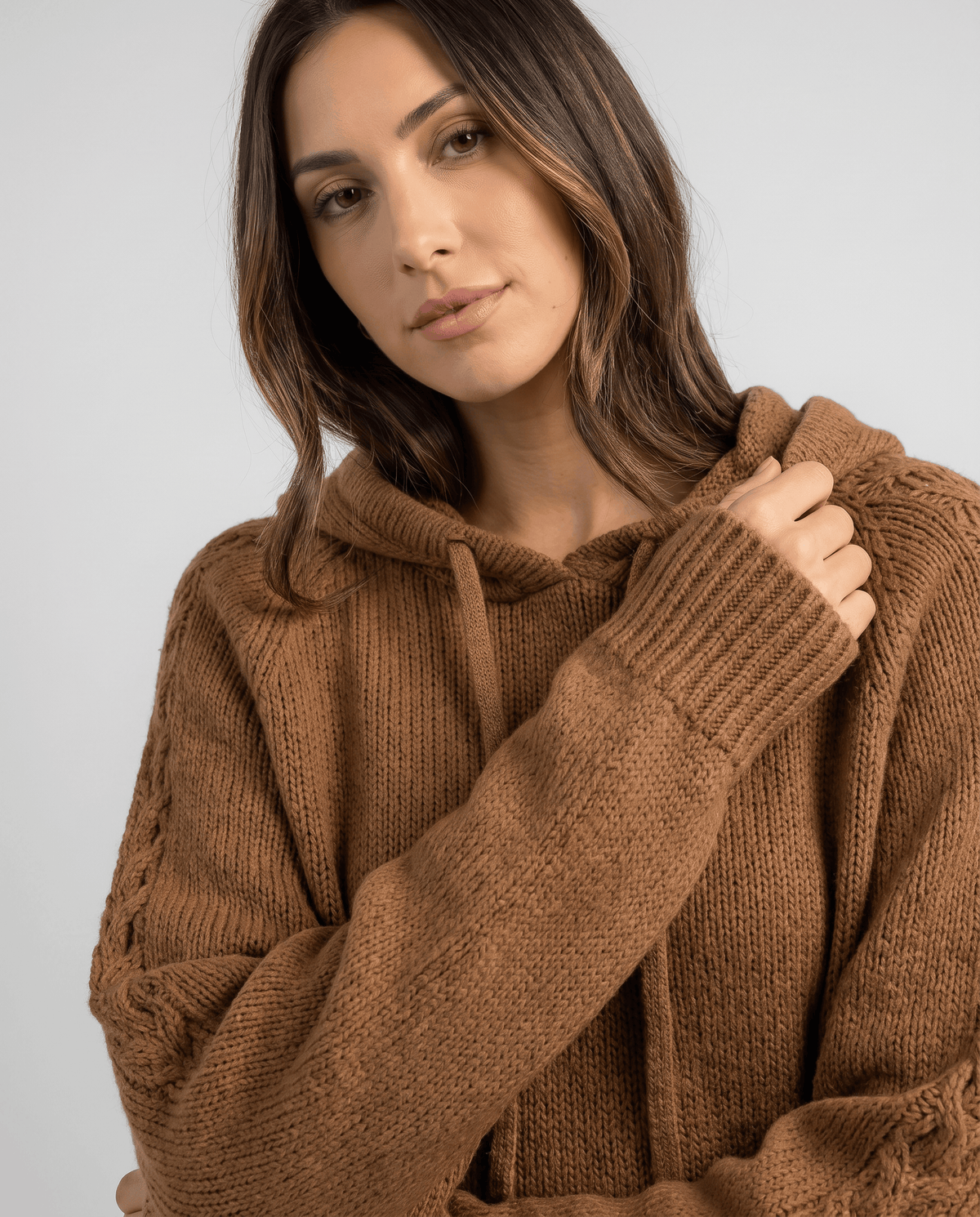 Close-up of the brown hooded sweater with the hood, drawstring and ribbed cuff