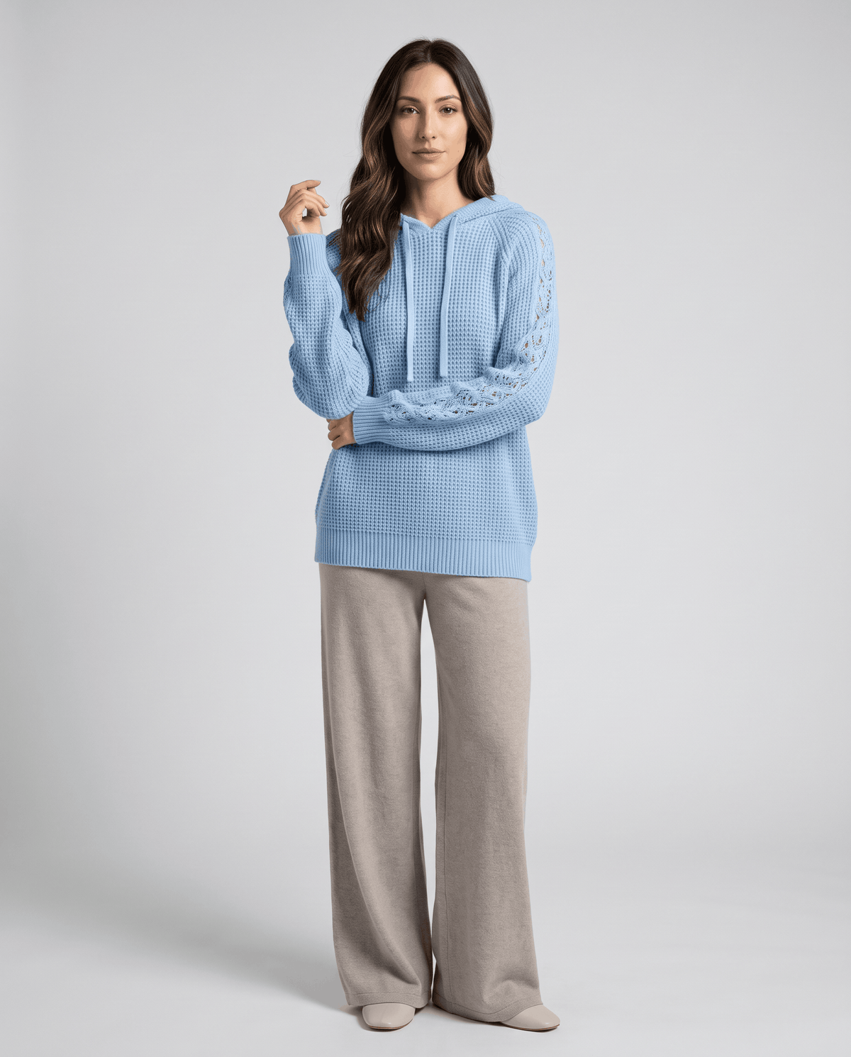 Full-length look pairing the light blue hooded sweater with taupe wide-leg pants
