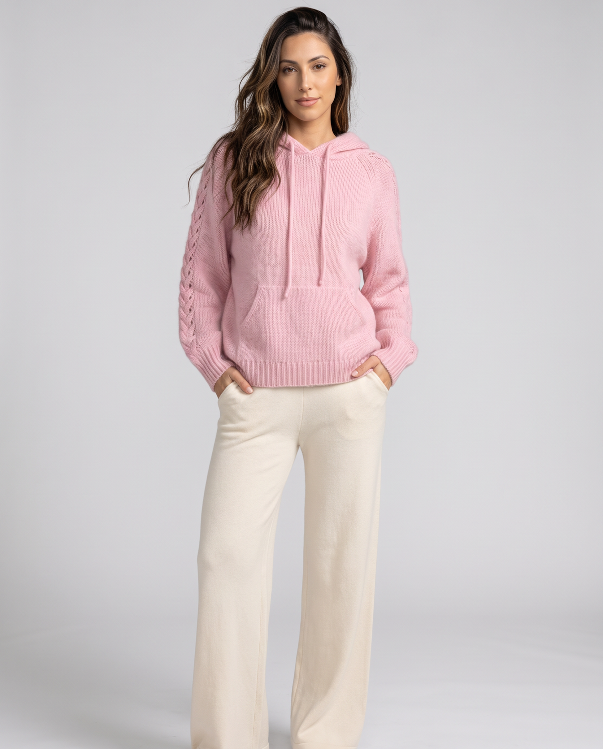 Full-length look pairing the pink hooded sweater with cream wide-leg pants