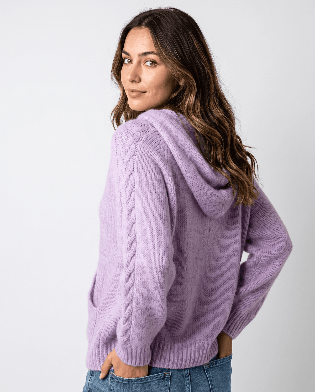 Over-the-shoulder angle of the purple hooded sweater showing the sleeve and hood