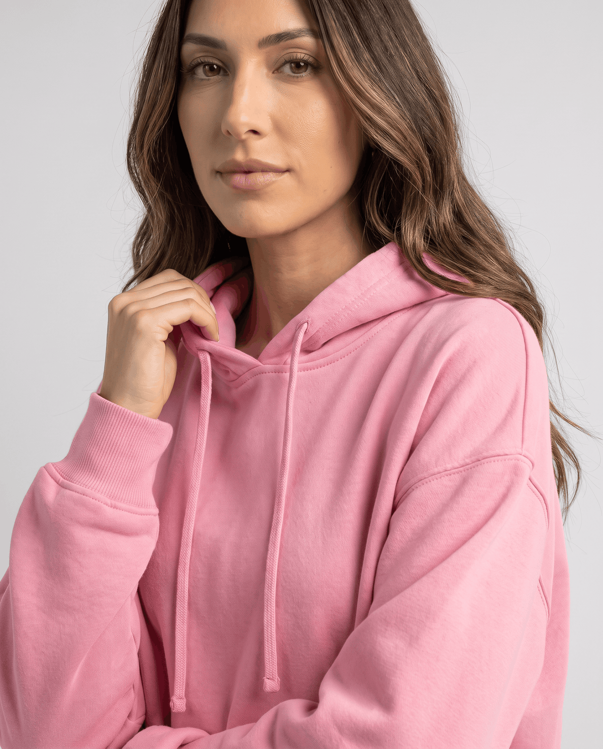 Close-up of the pink hood, drawstring and dropped shoulder seam