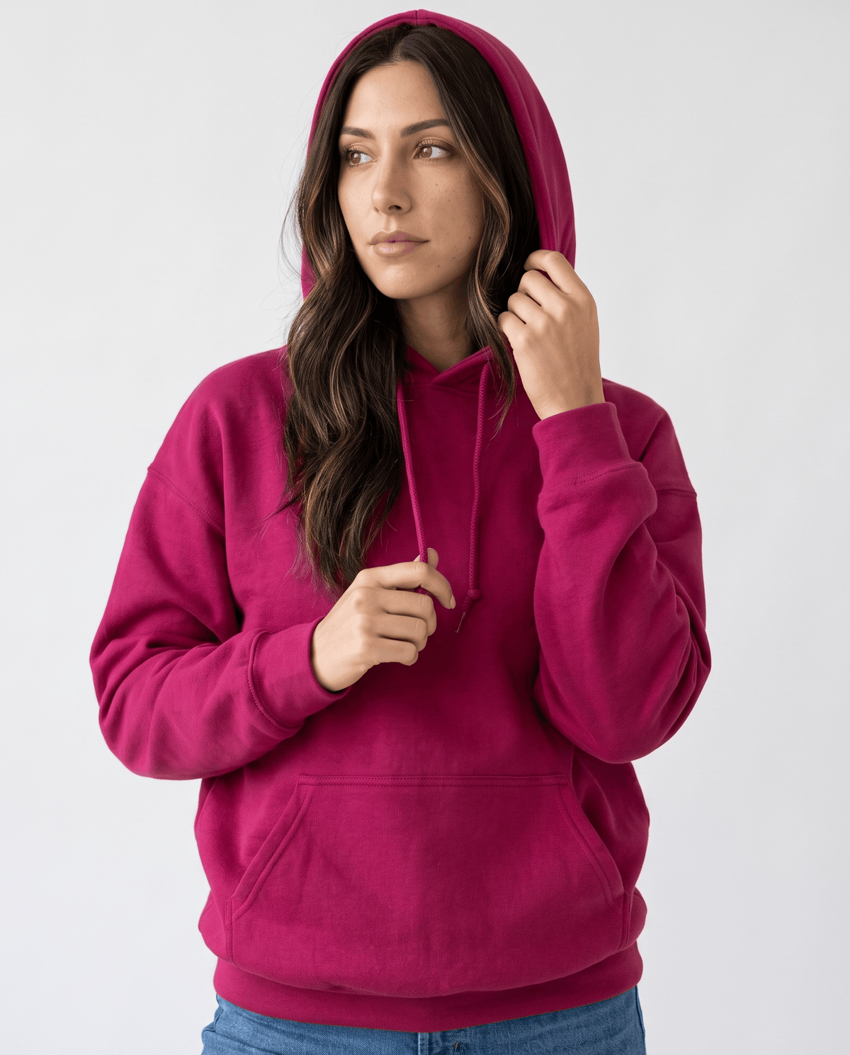 Red hoodie worn with the hood up and one hand raised to the drawstring, front view