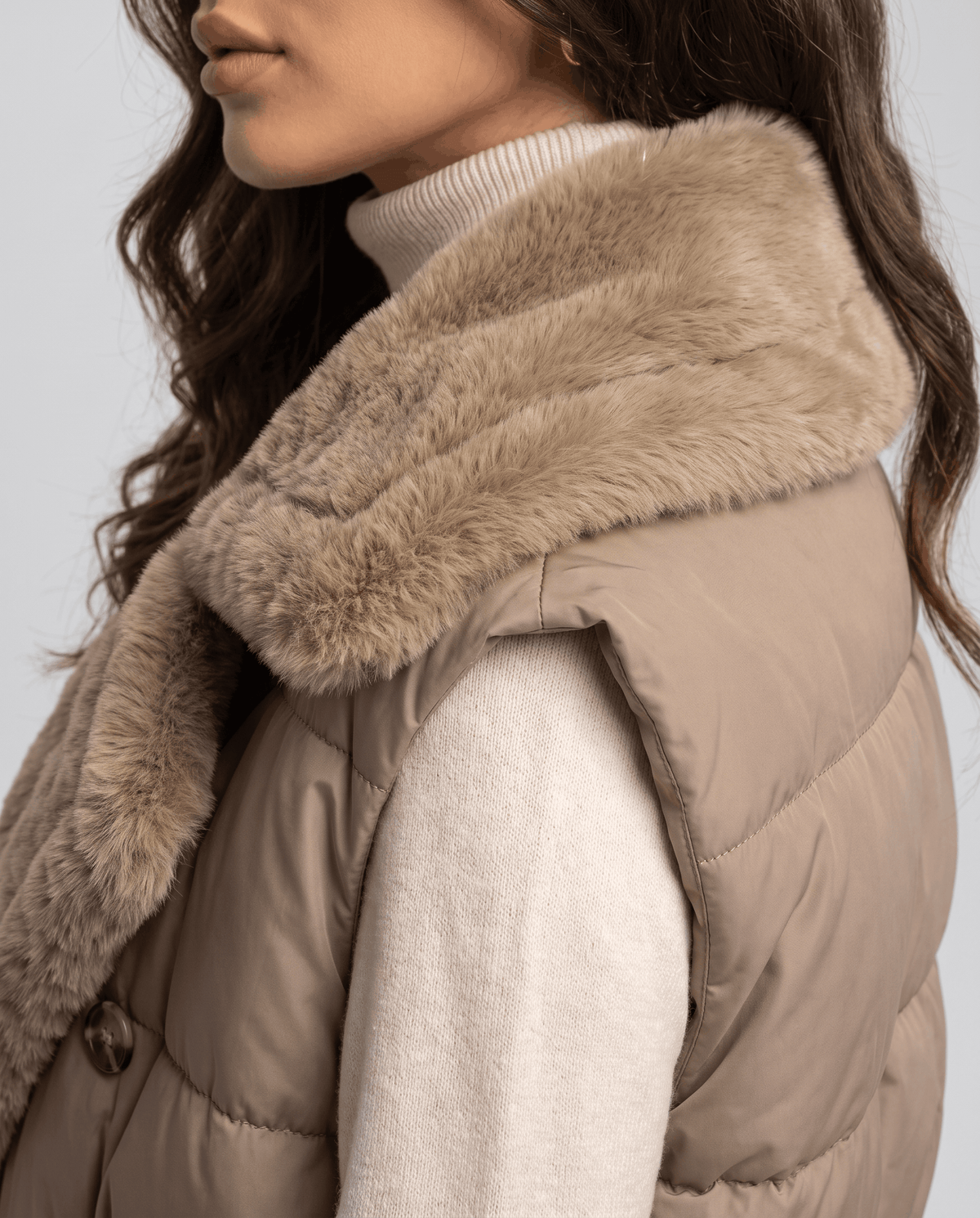 Side view of khaki padded vest plush collar and sleeveless armhole