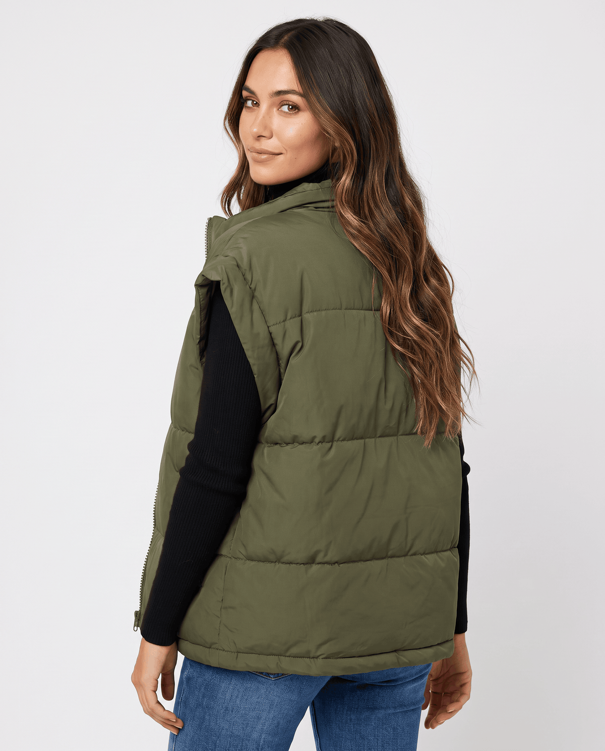 Back view of green padded vest with a loose shape through the waist