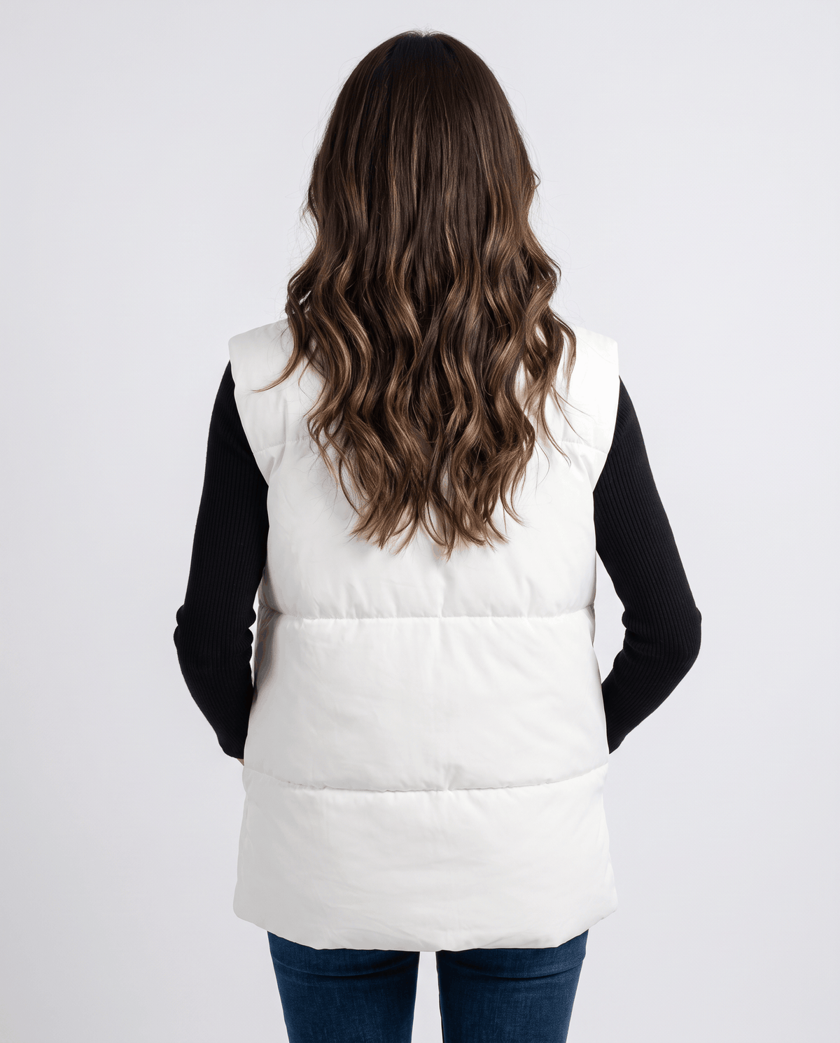Back view of white padded vest with horizontal padded sections