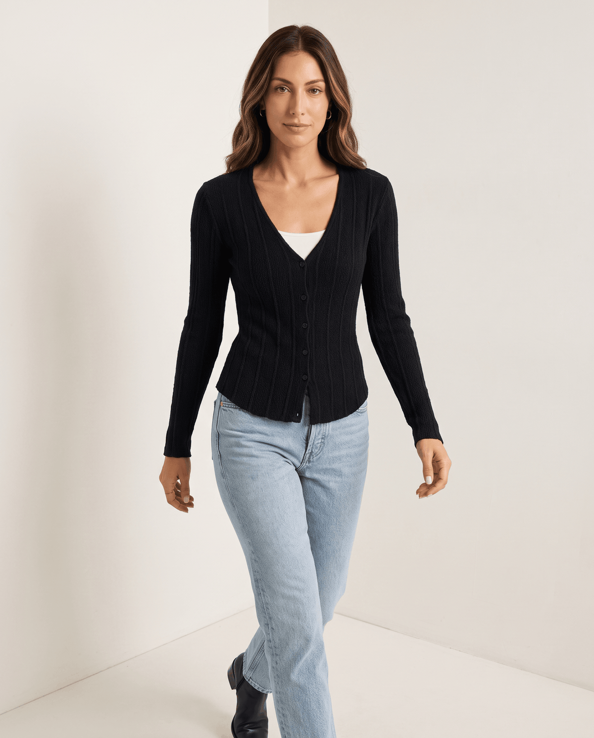 Full-length look with black ribbed button-front cardigan and light blue jeans