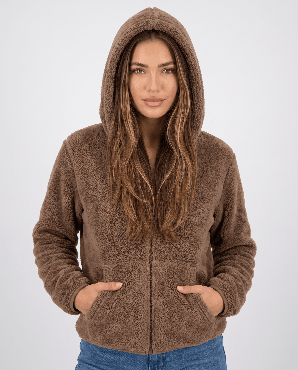 Women's sherpa fleece zip hoodie in brown with the hood up and hands in pockets
