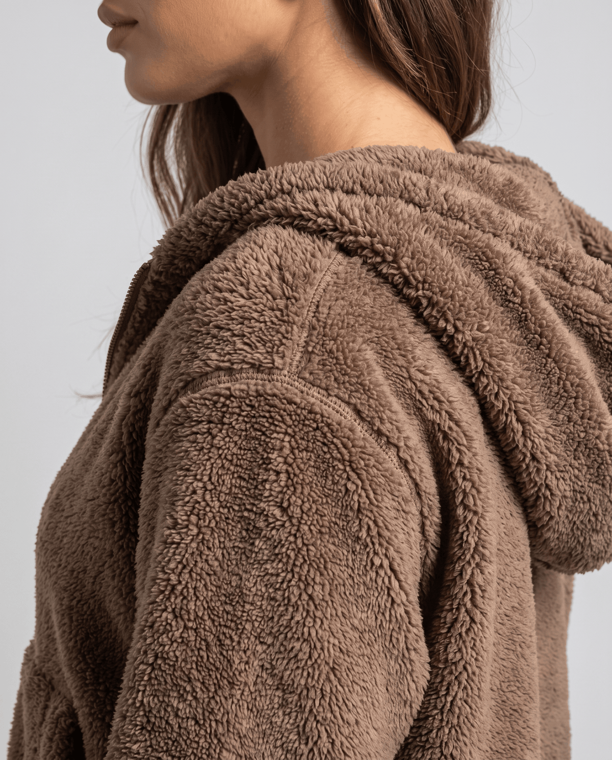 Side close-up of brown sherpa hood showing the soft fuzzy fleece texture