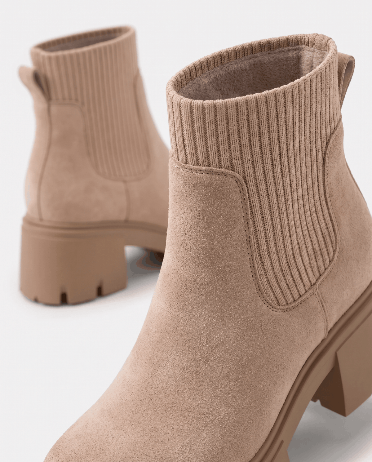 Close-up of ribbed elastic panel and lugged sole on apricot suede