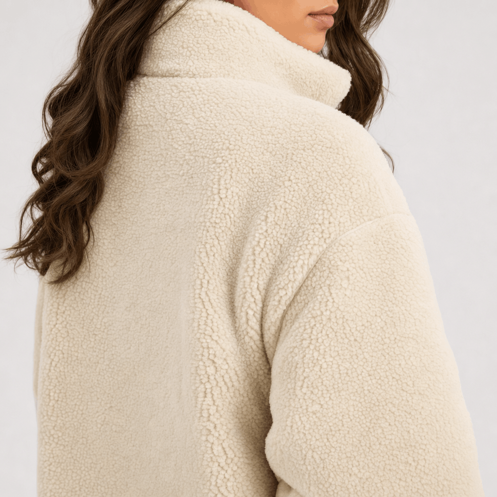 Back and side close-up of the cream sherpa jacket, showing the soft textured fabric and relaxed silhouette.