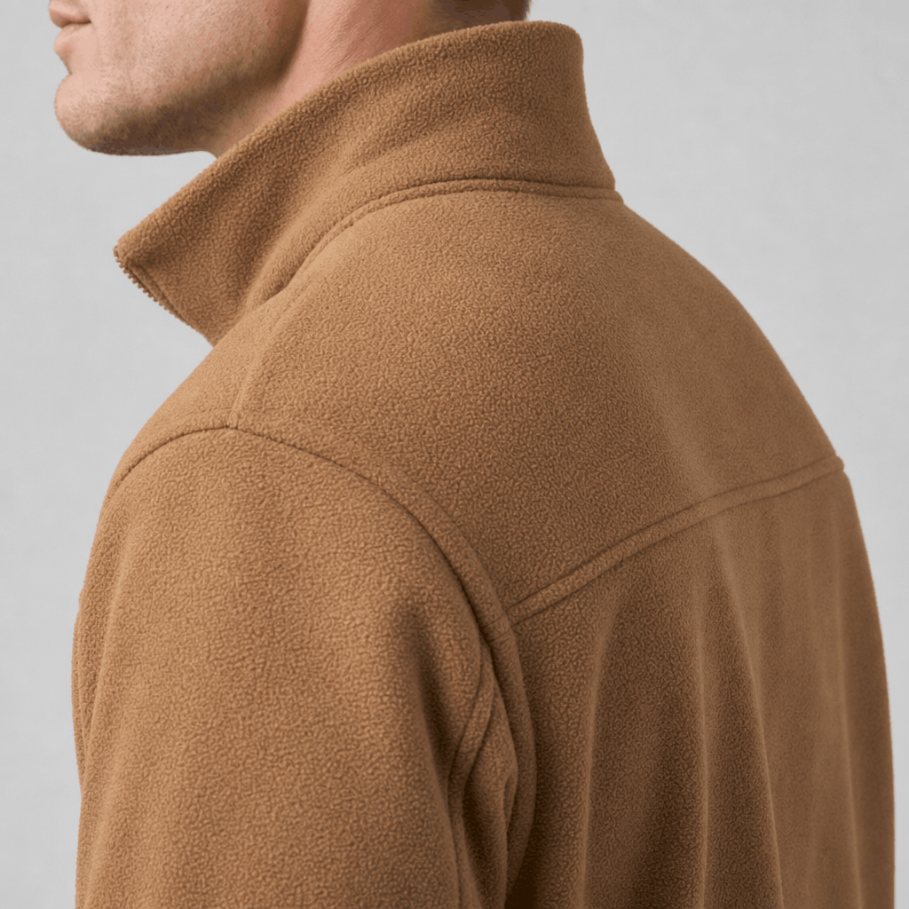 Close-up back and side view of the camel brown jacket, highlighting the raised beige collar and textured fabric.
