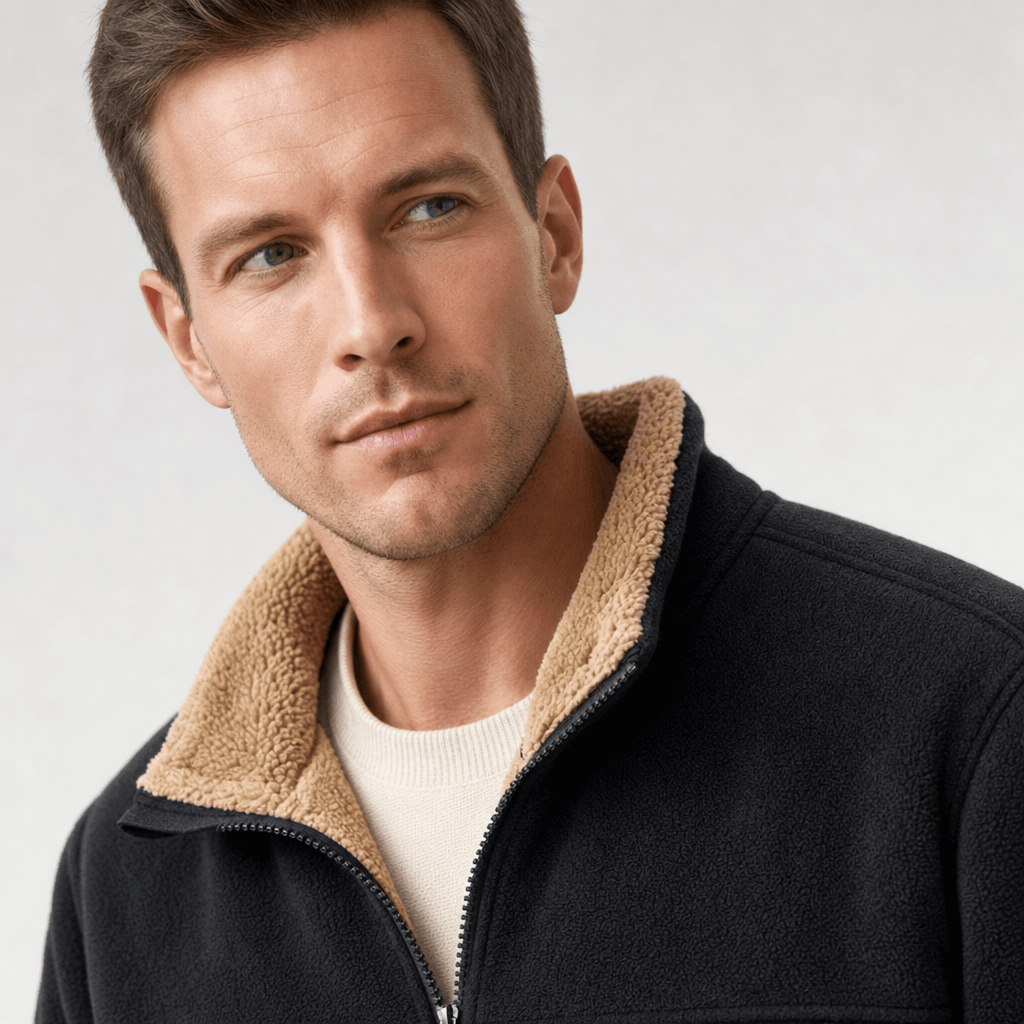 Detailed view of the black jacket, highlighting the beige collar and upper chest.
