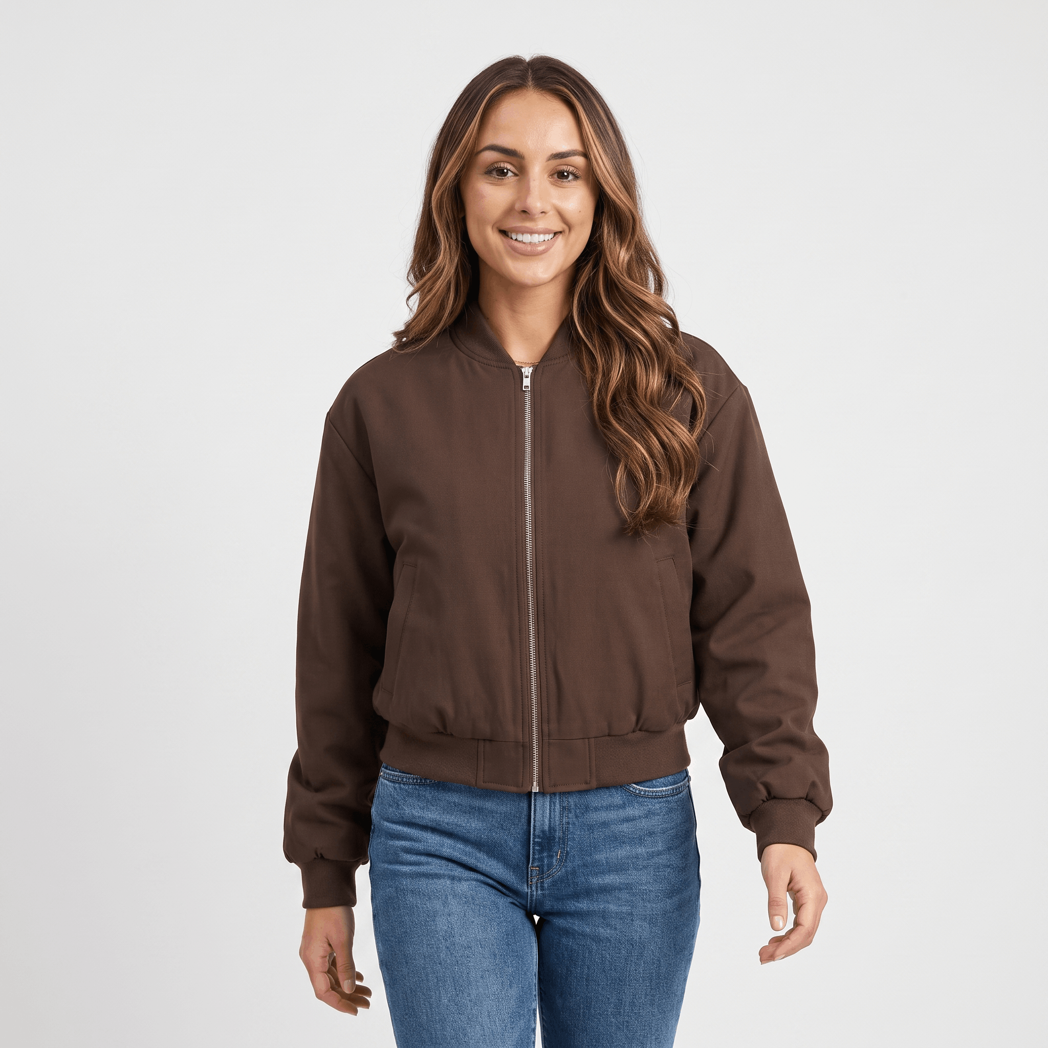 Female model wearing the dark brown bomber jacket with blue jeans.