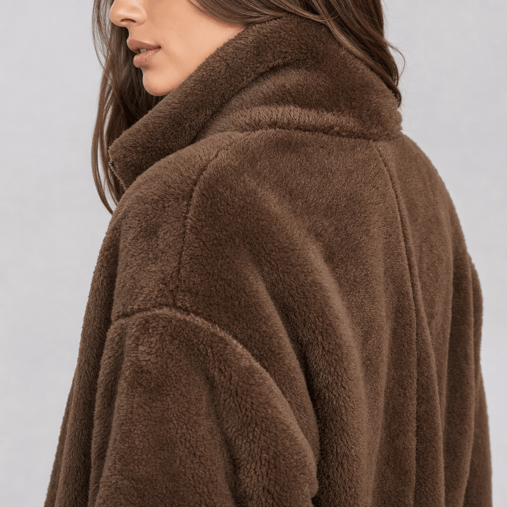 Back and side close-up of the brown sherpa fleece jacket, highlighting the plush texture and high collar.