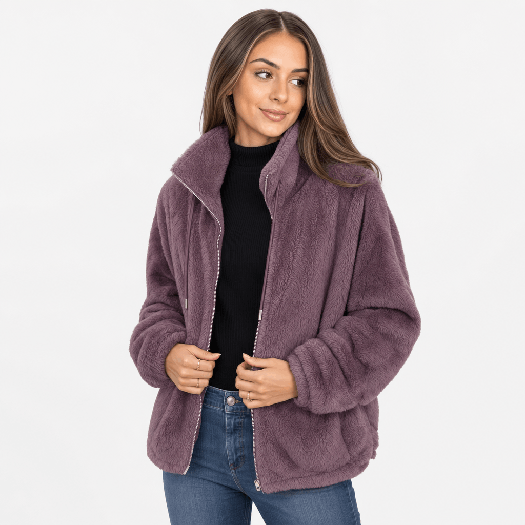 Female model wearing the dusty purple sherpa fleece zip-up jacket with blue jeans.