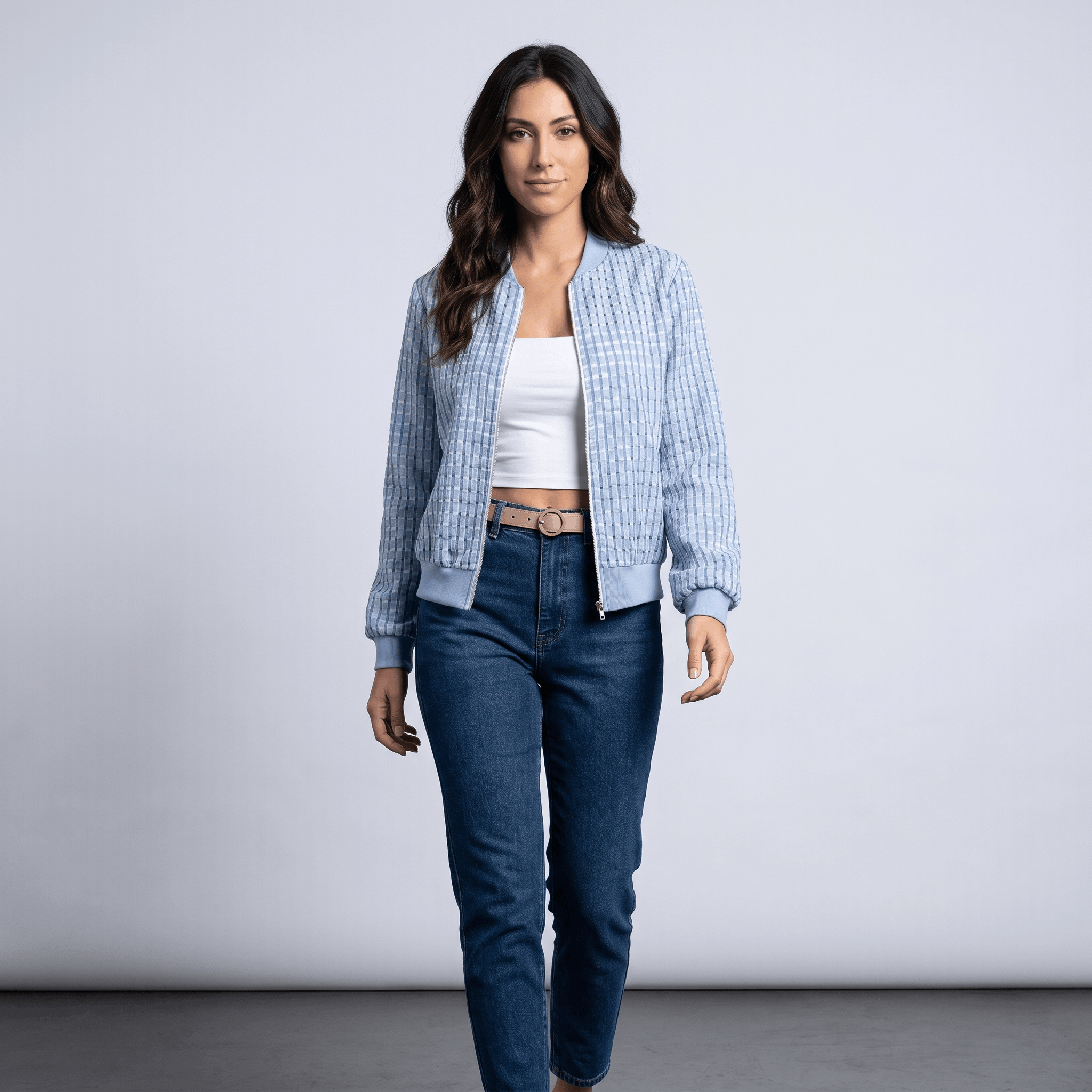 Female model wearing the light blue textured jacket with blue jeans and white sneakers.