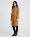 A woman wearing a brown belted wool trench coat with a tailored fit, lapel collar, and long sleeves