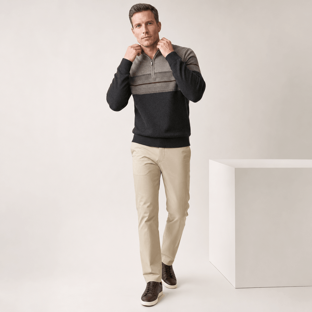 Man wearing the gray and black quarter-zip sweater in a full-body standing pose.