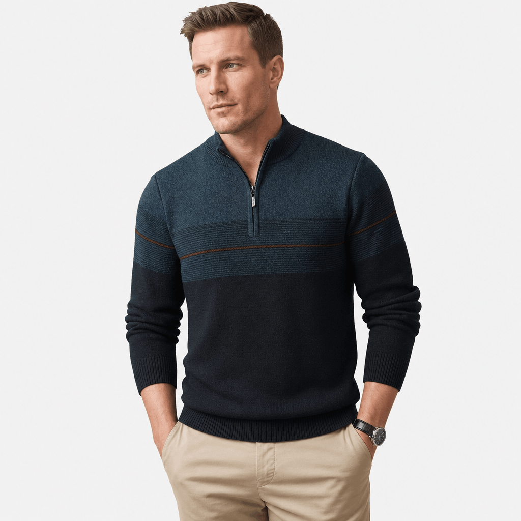 Man wearing a dark teal quarter-zip sweater with a textured upper panel and thin horizontal stripe detail.