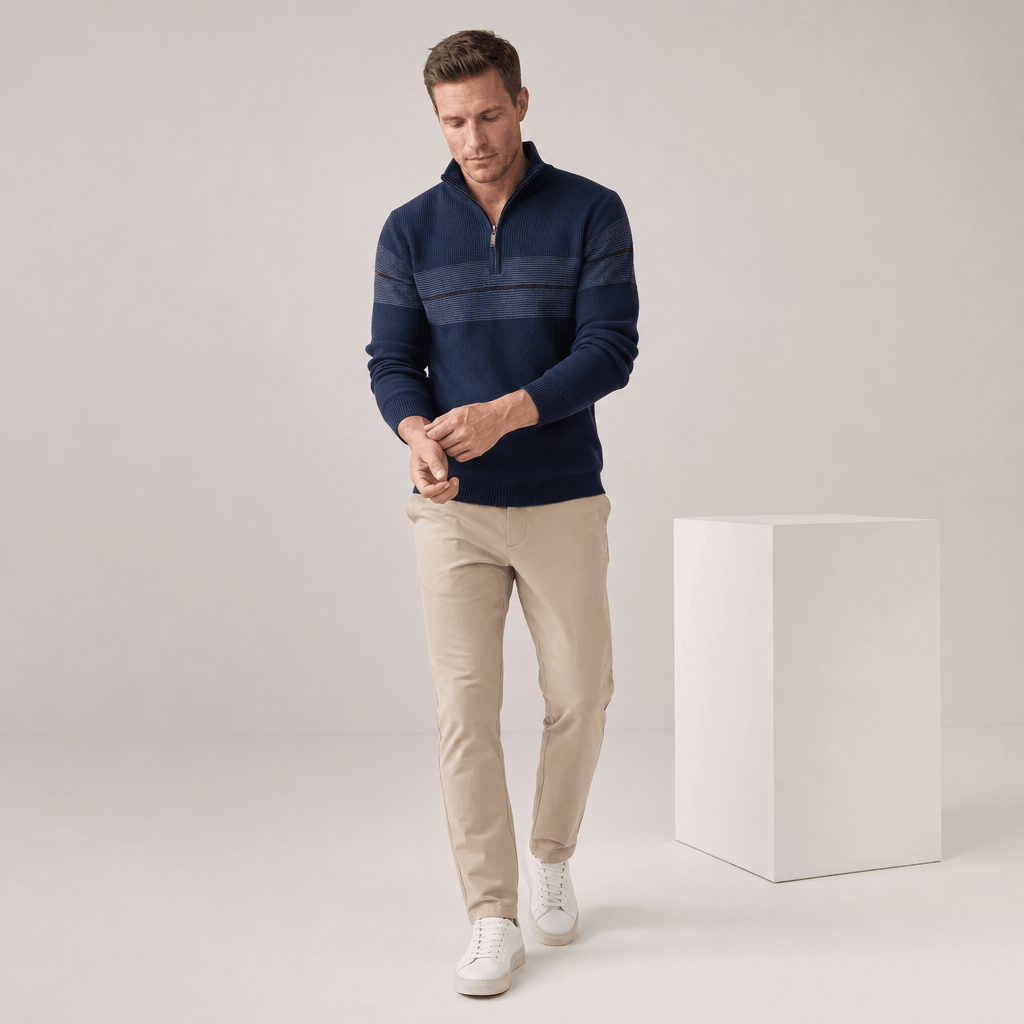 Man wearing the dark teal quarter-zip sweater with beige pants.