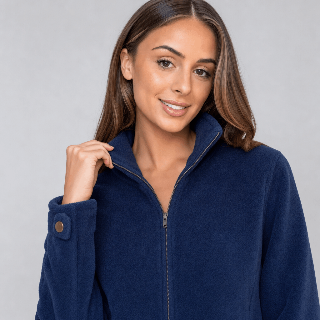 Close-up of the female model wearing the navy blue zip-up jacket, highlighting the stand collar and full-length zipper.