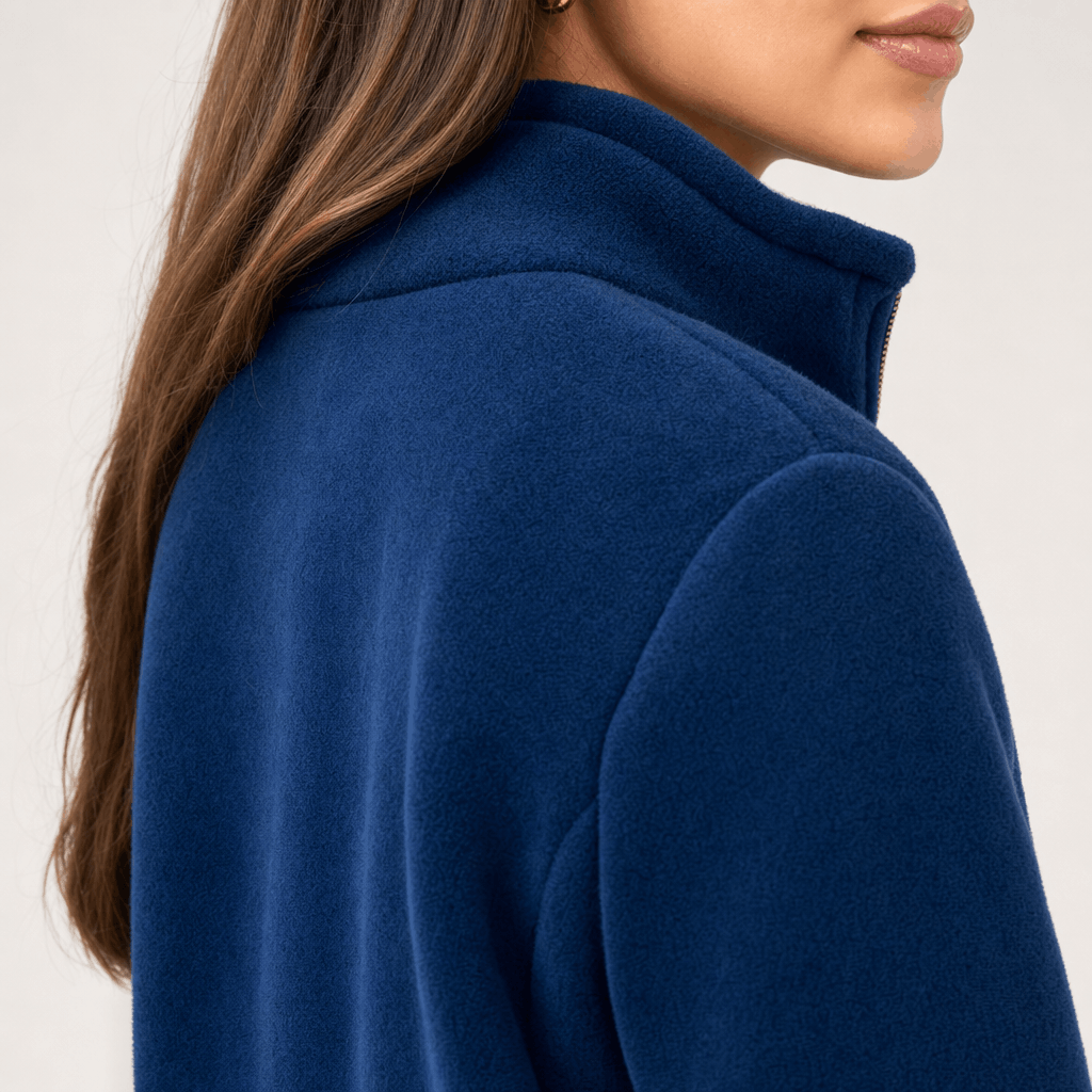 Back and side close-up of the navy blue jacket, showing the raised collar and smooth textured fabric.