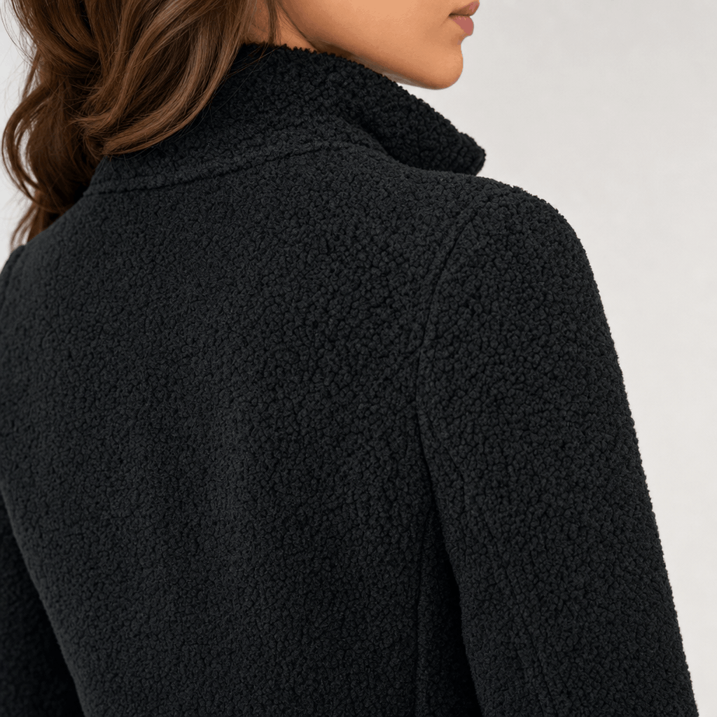 Back and side close-up of the black jacket, highlighting the stand collar and textured fabric.