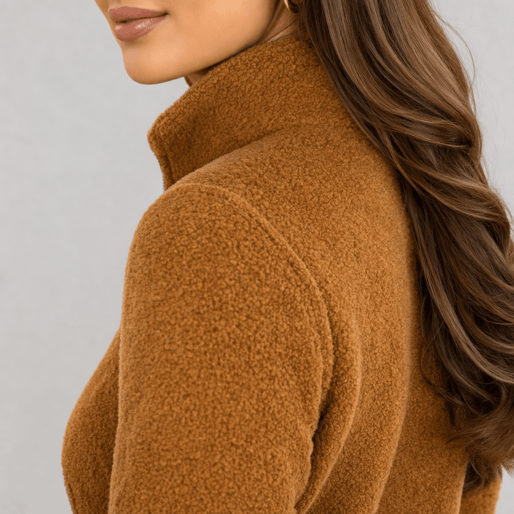 Back and side close-up of the camel brown jacket, showing the high collar and smooth textured fabric.