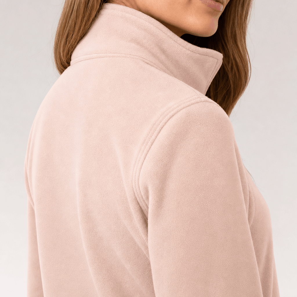 Back and side close-up of the light blush pink jacket, showing the high collar and fitted silhouette.