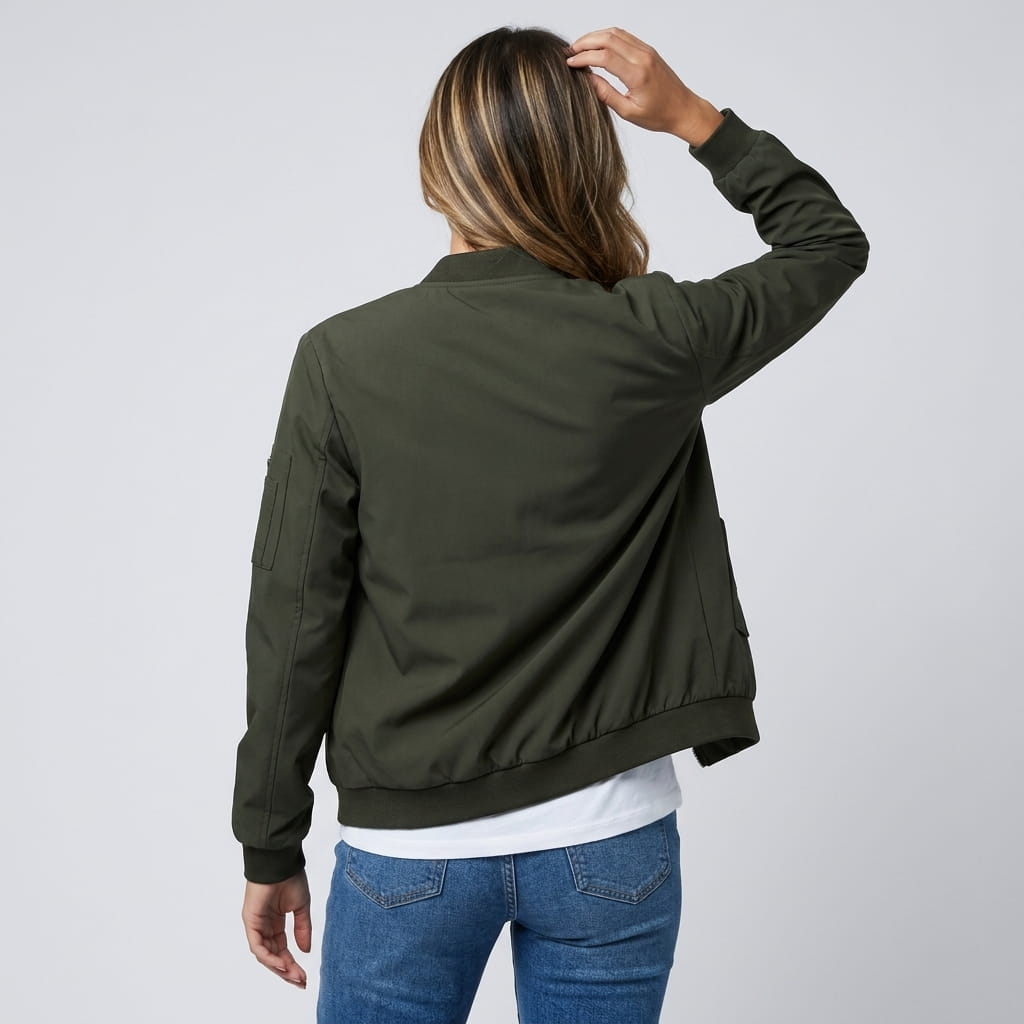 Female model wearing the olive green bomber jacket, showing the back and ribbed waistband.