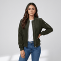 Female model wearing the olive green bomber jacket with blue jeans, posing with one hand on her hip.