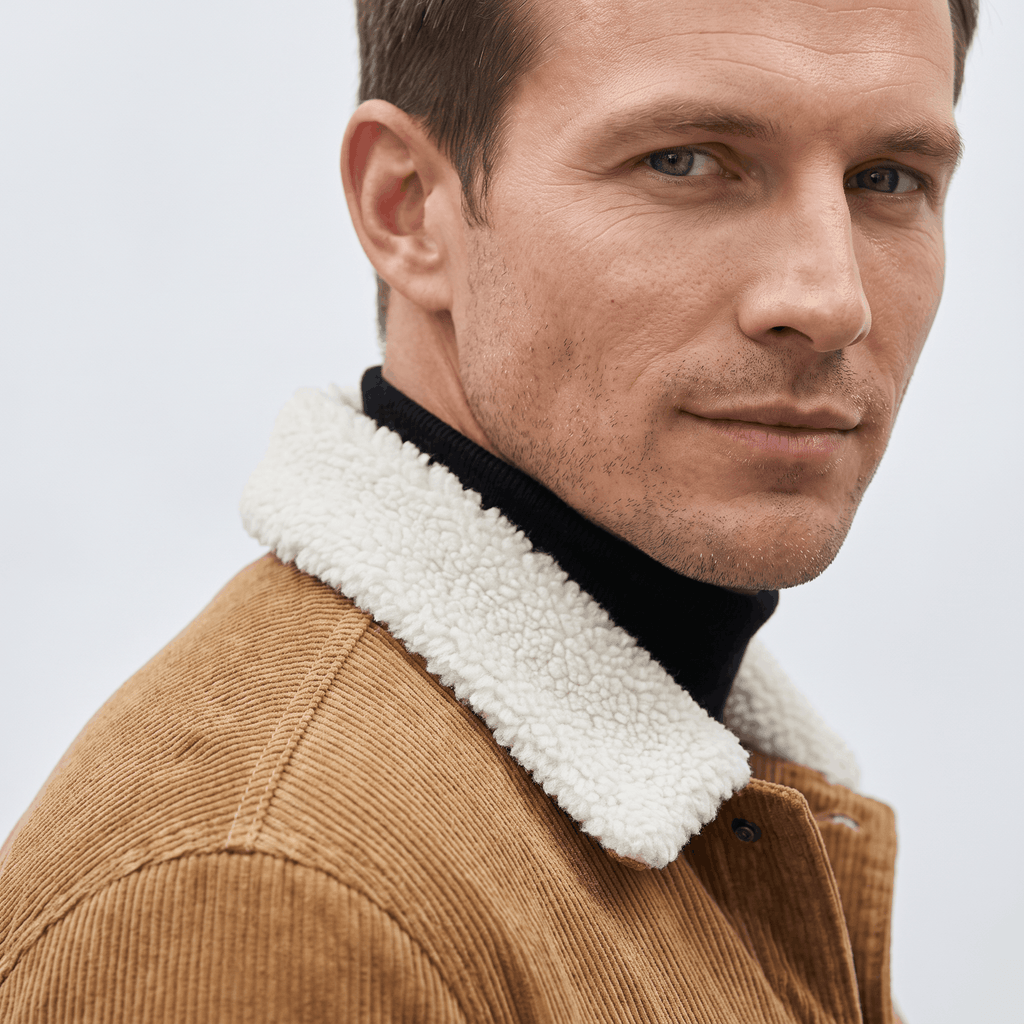 Tan corduroy trucker jacket featuring a soft white sherpa collar and snap-button front.