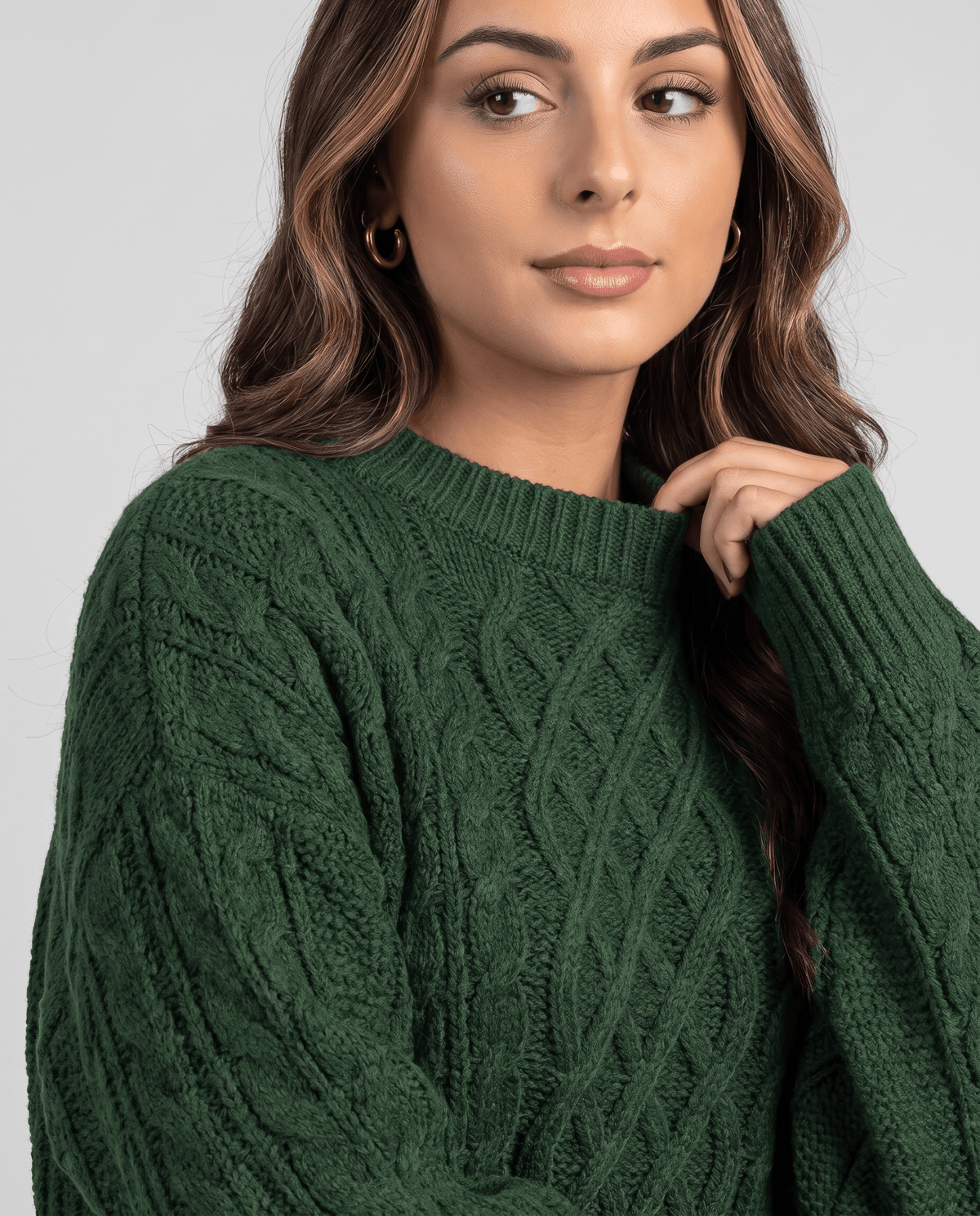 Green Cable Knit Sweater worn by a female model, shown in close-up with the textured cable knit pattern, relaxed fit, and long balloon sleeve.