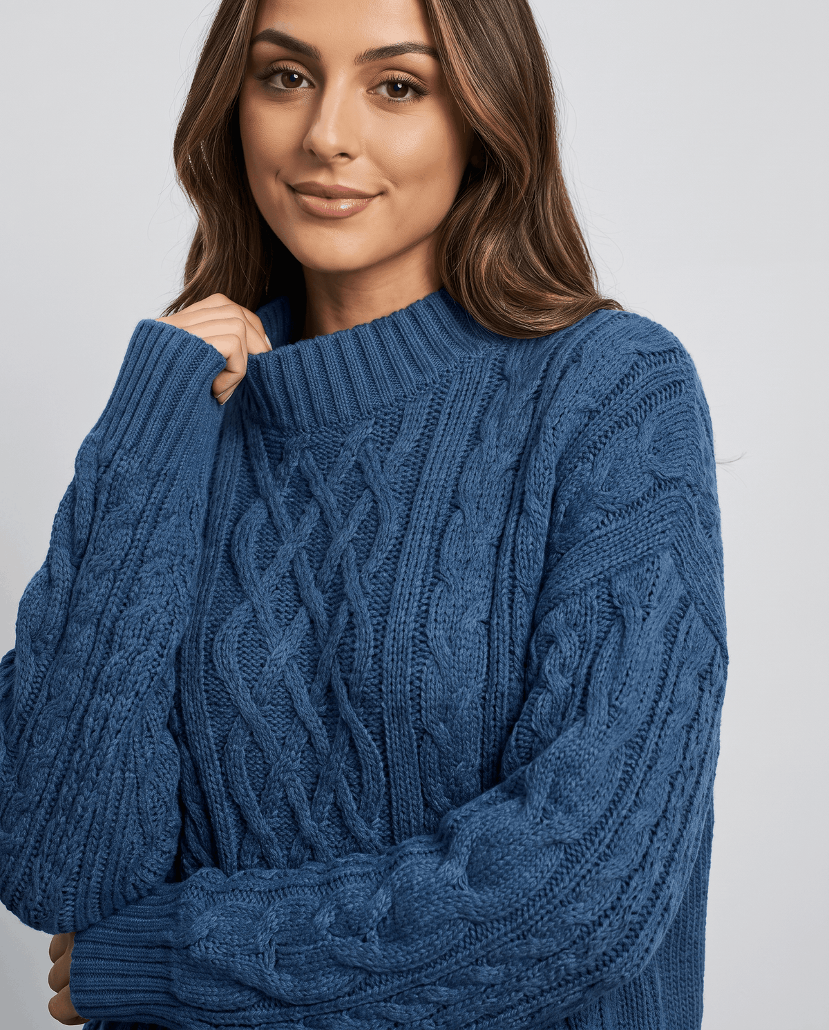 Blue Cable Knit Sweater worn by a female model, shown in close-up to highlight the textured cable knit pattern, oversized fit, and balloon sleeves.
